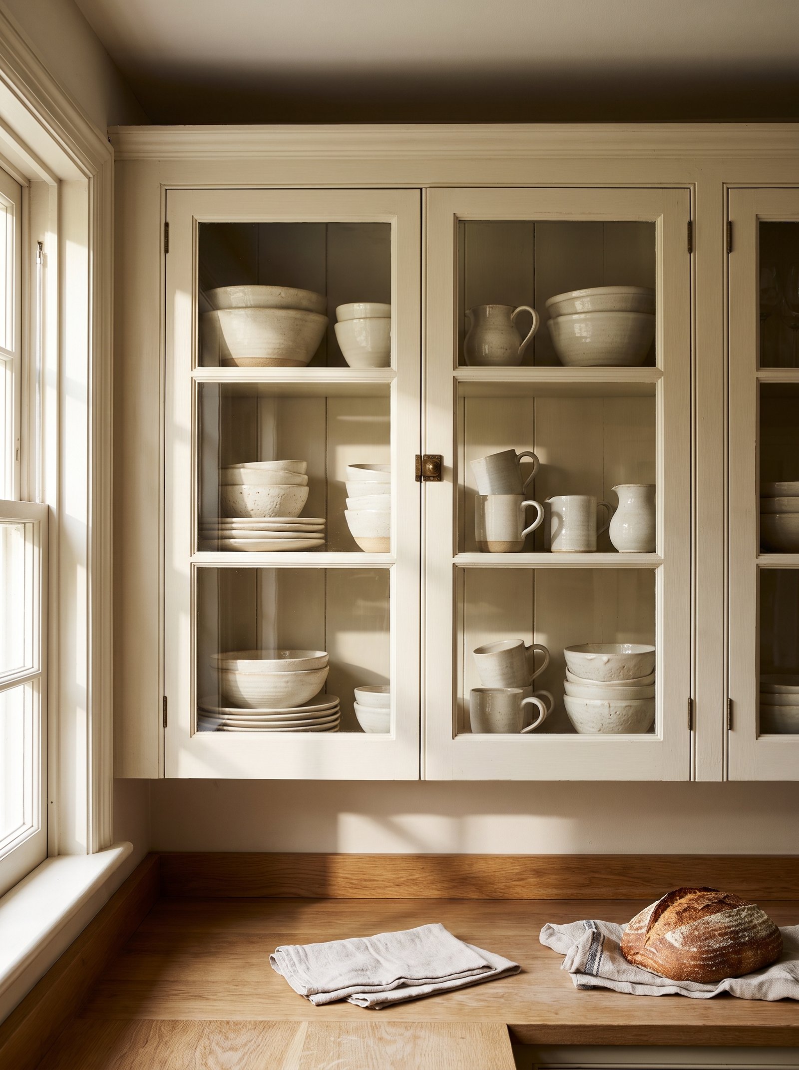Replace solid cabinet doors with glass fronts